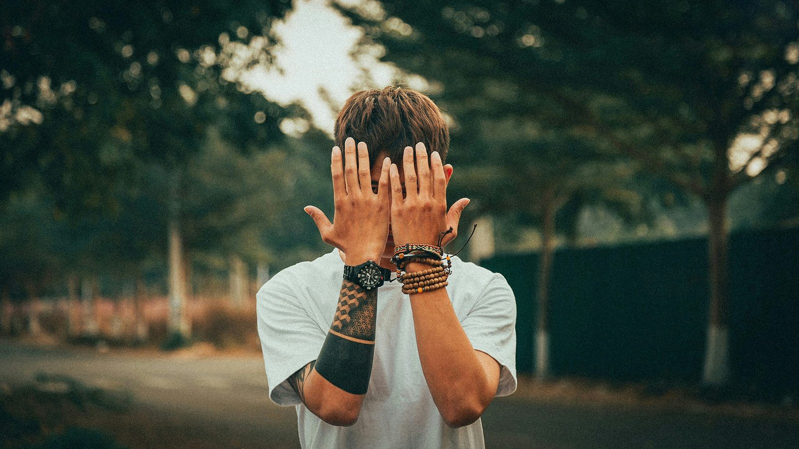 a man covering his face with his hands